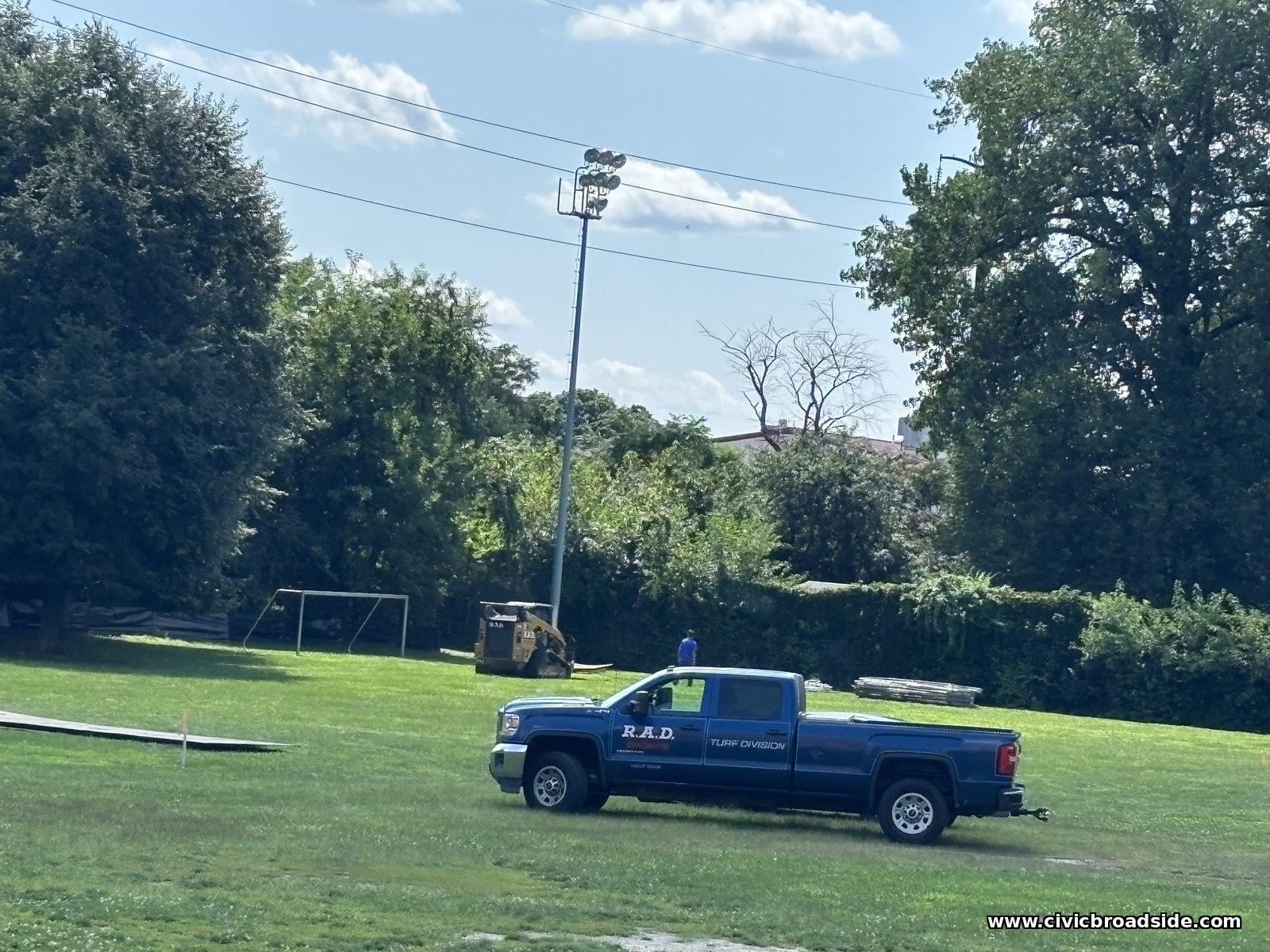 An R.A.D. Sports Turf Division truck and skid steer on the field at Roosevelt Park